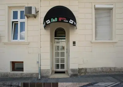 a building with a door with a sign over it at Booking En Suite in Belgrade