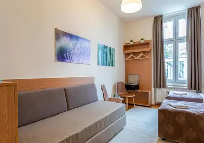 a living room with a couch and a bed at Booking En Suite in Belgrade