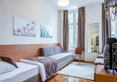a living room with a couch and a chair at Booking En Suite in Belgrade