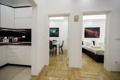 a kitchen and living room with a bed and a table at CENTAR Lux in Arandjelovac