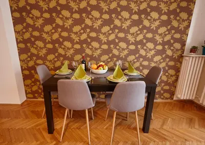 a dining room table with chairs and a bowl of fruit at Take 5 in Belgrade