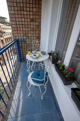 a table and chairs on a balcony with two drinks at Take 5 in Belgrade