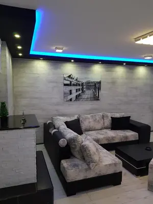 a living room with a couch and a blue light at Rabit delux II in Belgrade