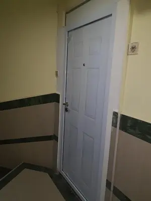 a white door in the corner of a room at Rabit delux II in Belgrade