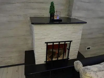 a fireplace in a living room with a black mantle at Rabit delux II in Belgrade