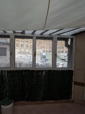a room with four windows with a view of a building at Rabit delux II in Belgrade