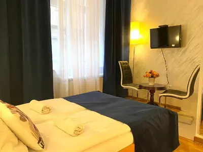 a hotel room with a bed and a tv at Villa Forever in Belgrade