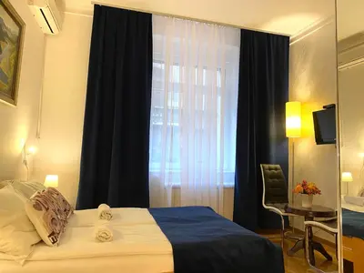a hotel room with a bed and a window at Villa Forever in Belgrade