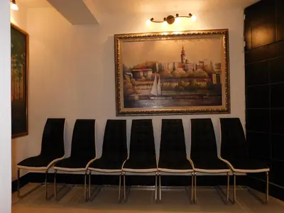 a group of chairs in a waiting room with a painting at Villa Forever in Belgrade