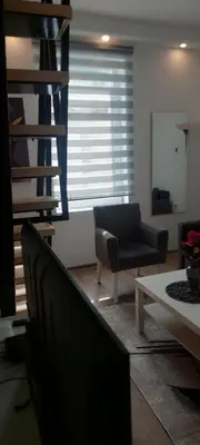 a living room with a couch and a table at Cute little apartment in Belgrade