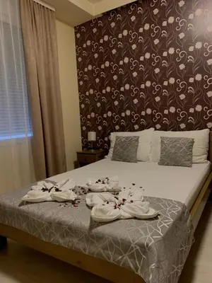 a bedroom with a bed with towels on it at Apartmani CENTAR- Smederevo in Smederevo