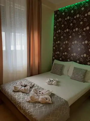 a bedroom with a bed with towels on it at Apartmani CENTAR- Smederevo in Smederevo