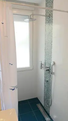 a bathroom with a shower with a glass window at Apartman Mia in Belgrade