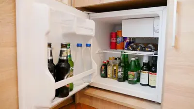 an open refrigerator filled with lots of drinks at Apartman Mia in Belgrade