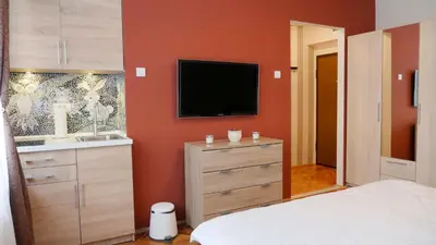a bedroom with a bed and a flat screen tv at Apartman Mia in Belgrade