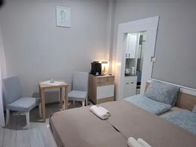 a bedroom with a bed and a table and chairs at SnowWhite New Apartment in Belgrade