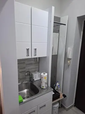 a kitchen with a sink and white cabinets at SnowWhite New Apartment in Belgrade