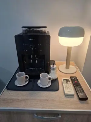 a coffee maker and two coffee cups on a table at SnowWhite New Apartment in Belgrade