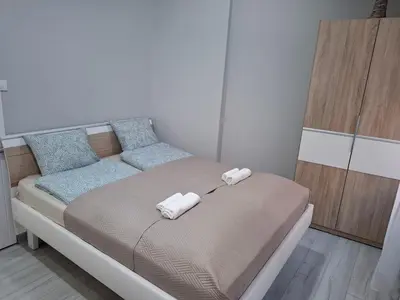 a bed with two pillows on it in a room at SnowWhite New Apartment in Belgrade