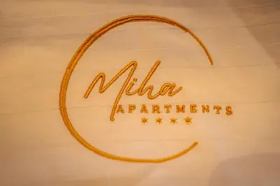 a sign that reads milka apartments with a ring on it at Miha Luxury Apartment in Belgrade