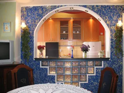 a kitchen with an archway in a room at Garden in Belgrade