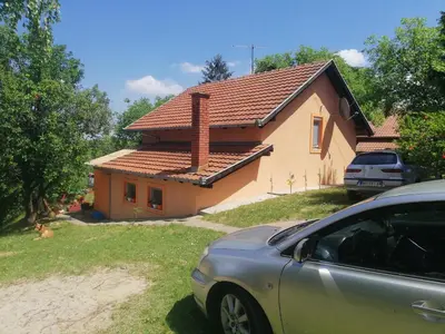 a house with a car parked in front of it at Guest House Jevtović in Sremski Karlovci