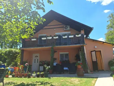a house with a balcony on top of it at Guest House Jevtović in Sremski Karlovci