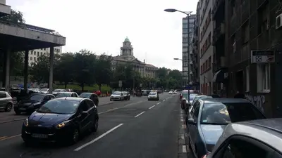a street with cars parked on the side of the road at City centre penthouse in Belgrade