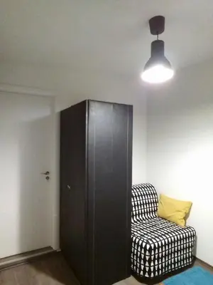 a room with a black cabinet and a couch at City centre penthouse in Belgrade