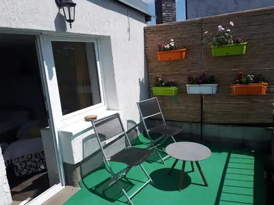 two chairs and a table on a patio at City centre penthouse in Belgrade