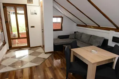 a living room with a couch and a table at Apartman Rustik in Belgrade