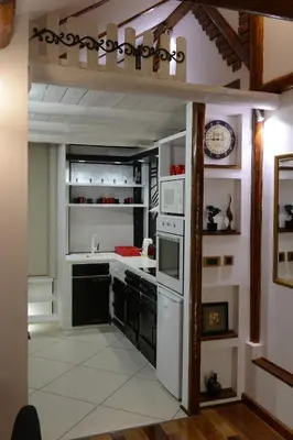 a kitchen with white appliances and black cabinets at Apartman Rustik in Belgrade