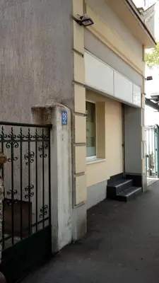 a building with a gate and a window and stairs at Apartman Rustik in Belgrade