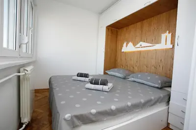 a bedroom with a bed with two pillows on it at White Lux apartment in Belgrade