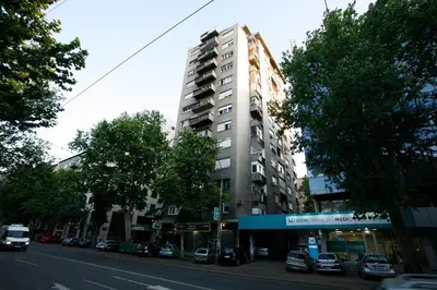 a tall building on the side of a city street at White Lux apartment in Belgrade