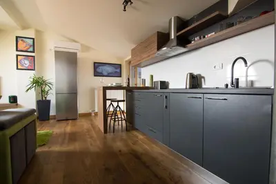 a kitchen with gray cabinets and a counter top at St. Sava Temple/Slavija square in Belgrade