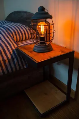 a lantern on a table next to a bed at St. Sava Temple/Slavija square in Belgrade