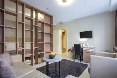 a living room with a couch and a table at Hotel Srbija Garden-FREE PARKING-upon availability in Belgrade