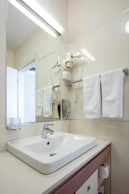 a bathroom with a white sink and a mirror at Hotel Srbija Garden-FREE PARKING-upon availability in Belgrade