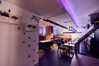 a restaurant with tables and chairs and purple lighting at Hotel Srbija Garden-FREE PARKING-upon availability in Belgrade