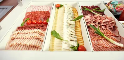a refrigerator filled with different types of meats and cheese at Hotel Srbija Garden-FREE PARKING-upon availability in Belgrade