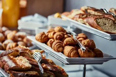 a bunch of different types of bread and pastries at Hotel Srbija Garden-FREE PARKING-upon availability in Belgrade