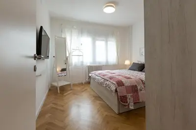 a bedroom with a bed and a window at Belgrade Center Apartment II in Belgrade