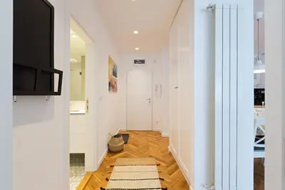 a hallway with a television and a rug on the floor at Belgrade Center Apartment II in Belgrade
