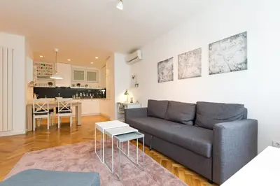a living room with a couch and a kitchen at Belgrade Center Apartment II in Belgrade