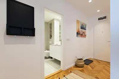 a living room with a flat screen tv on a wall at Belgrade Center Apartment II in Belgrade