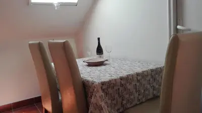 a table with a bottle of wine and two glasses at Apartment Dixy in Belgrade