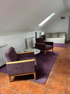 a living room with two chairs and a couch at Apartment Dixy in Belgrade