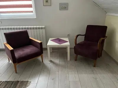 two chairs and a table in a room at Apartment Dixy in Belgrade
