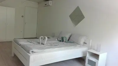 a bedroom with a white bed with swans on it at Apartment Dixy in Belgrade